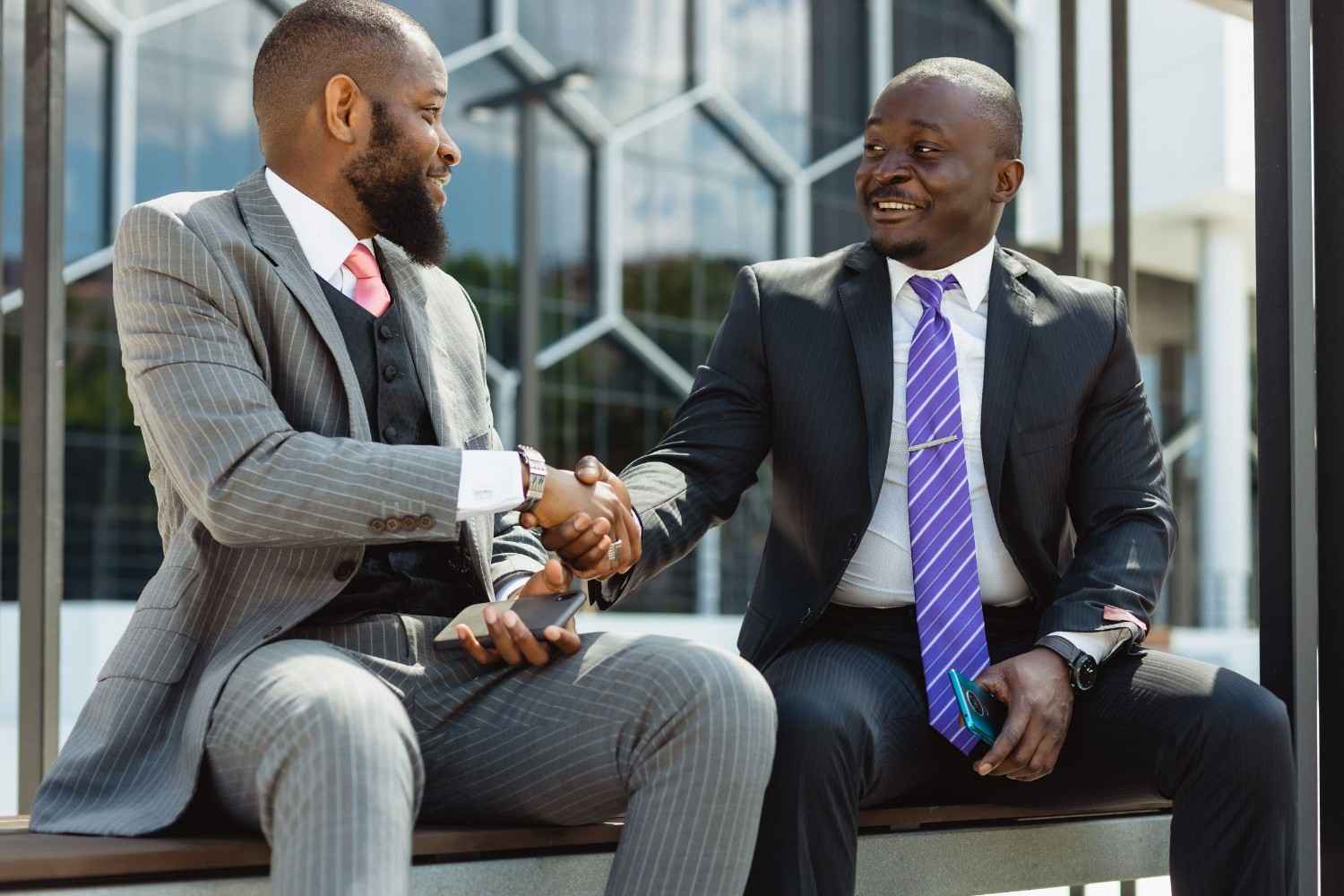 Two Businessmen In Suits Communicate