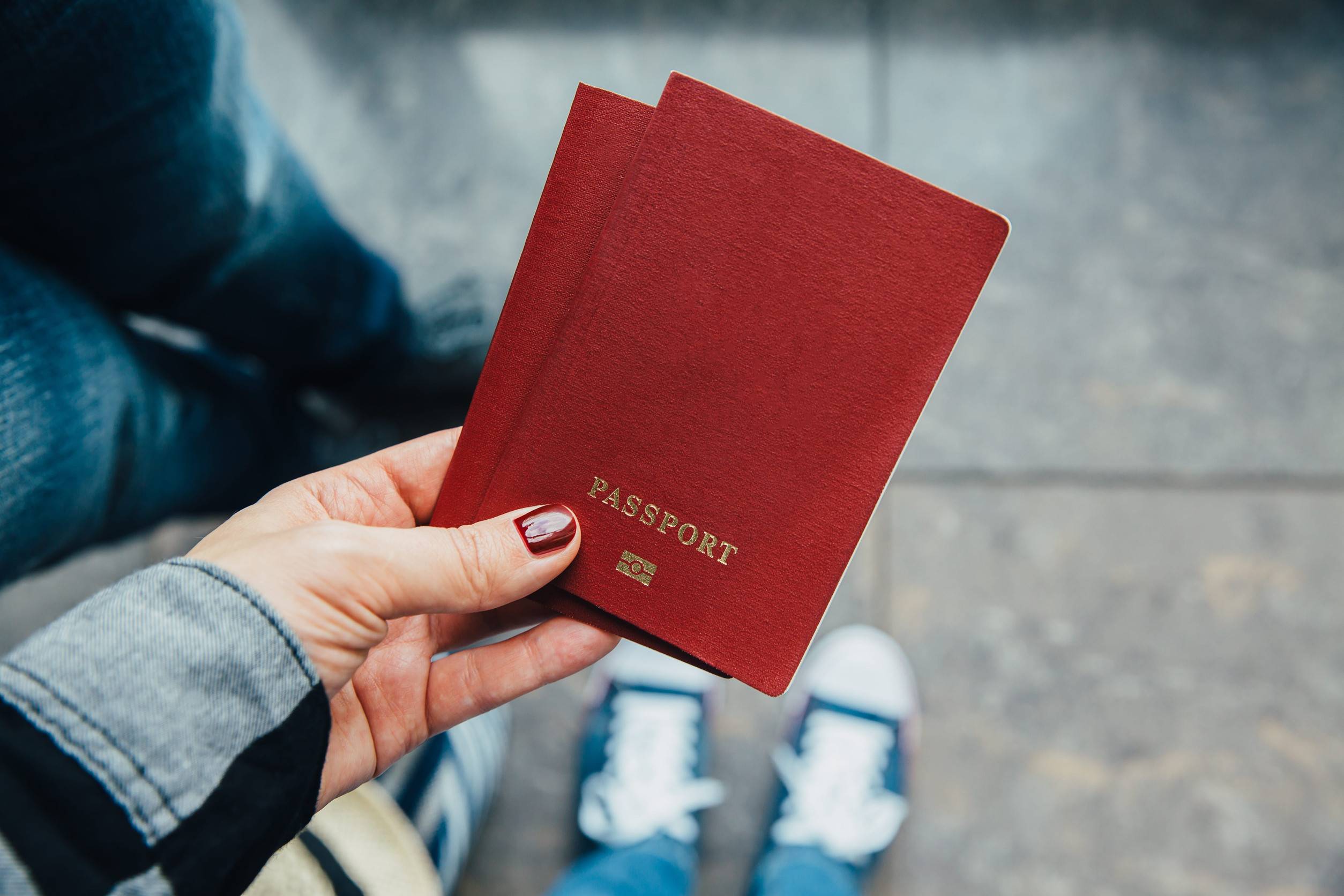 Woman Holding Passports at Airport